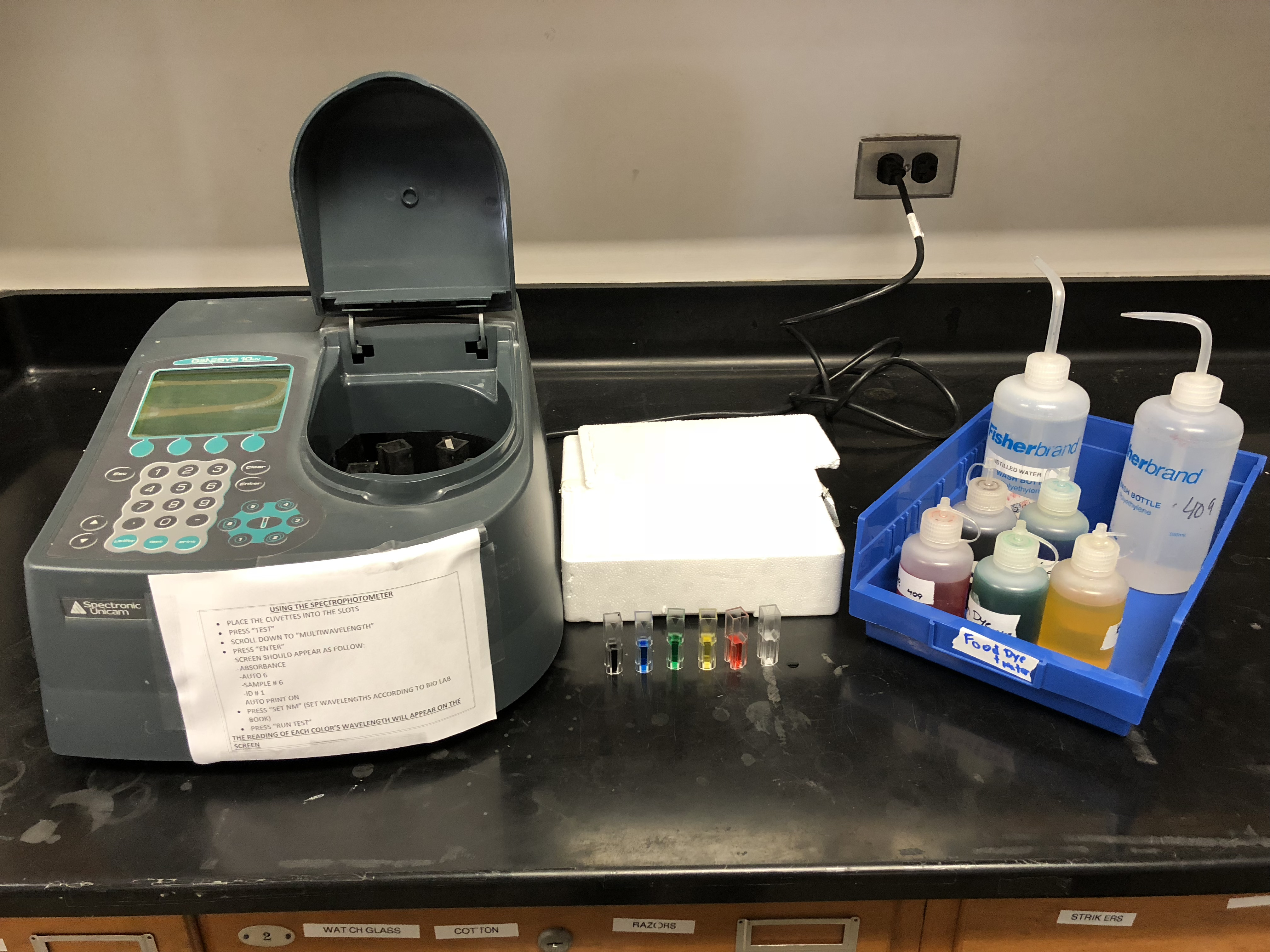Spectrophotometer and cuvettes with dye solutions.
